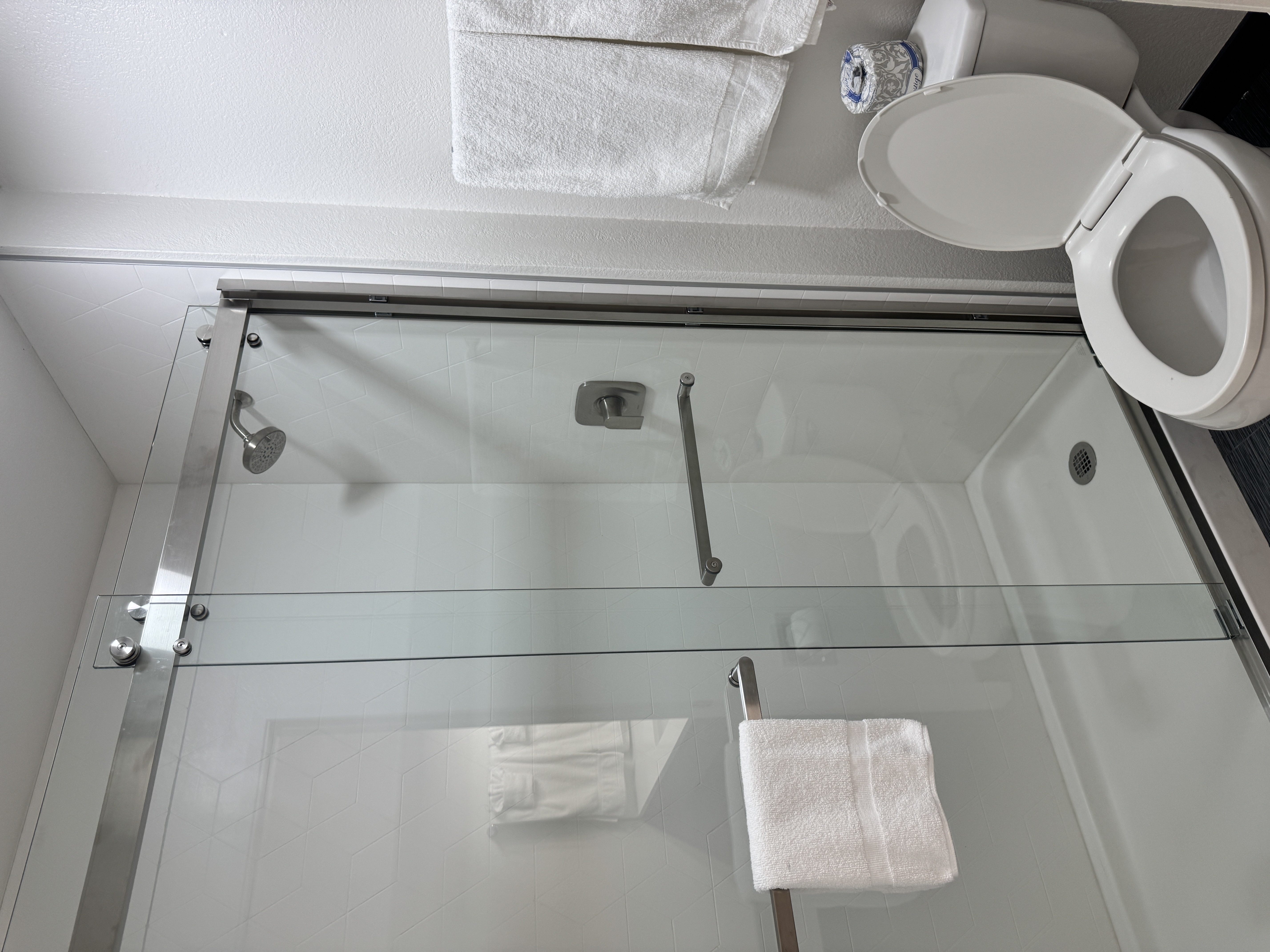 Guest bathroom with glass shower and fresh towels