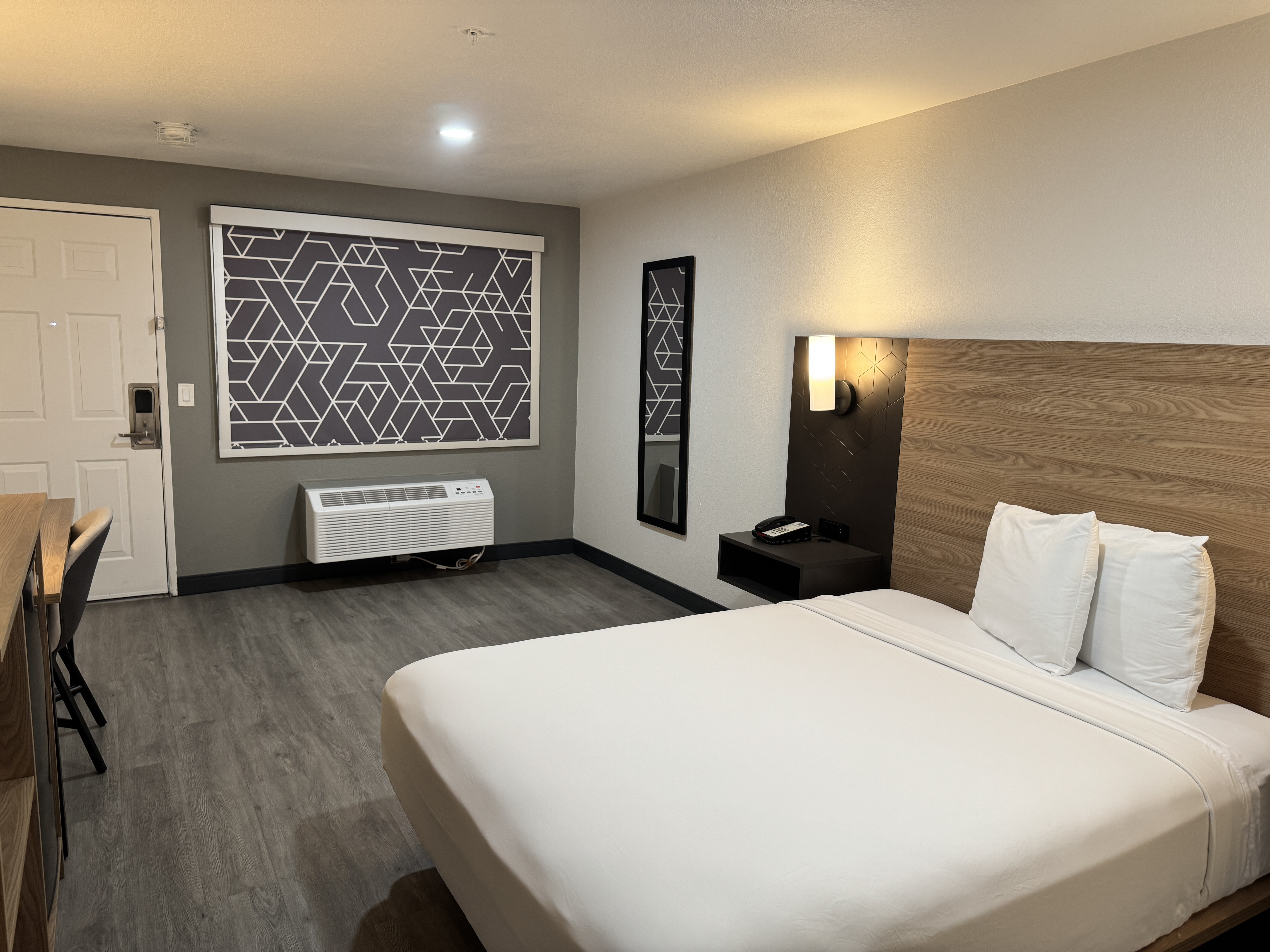 King room with desk, television, microwave, and refrigerator