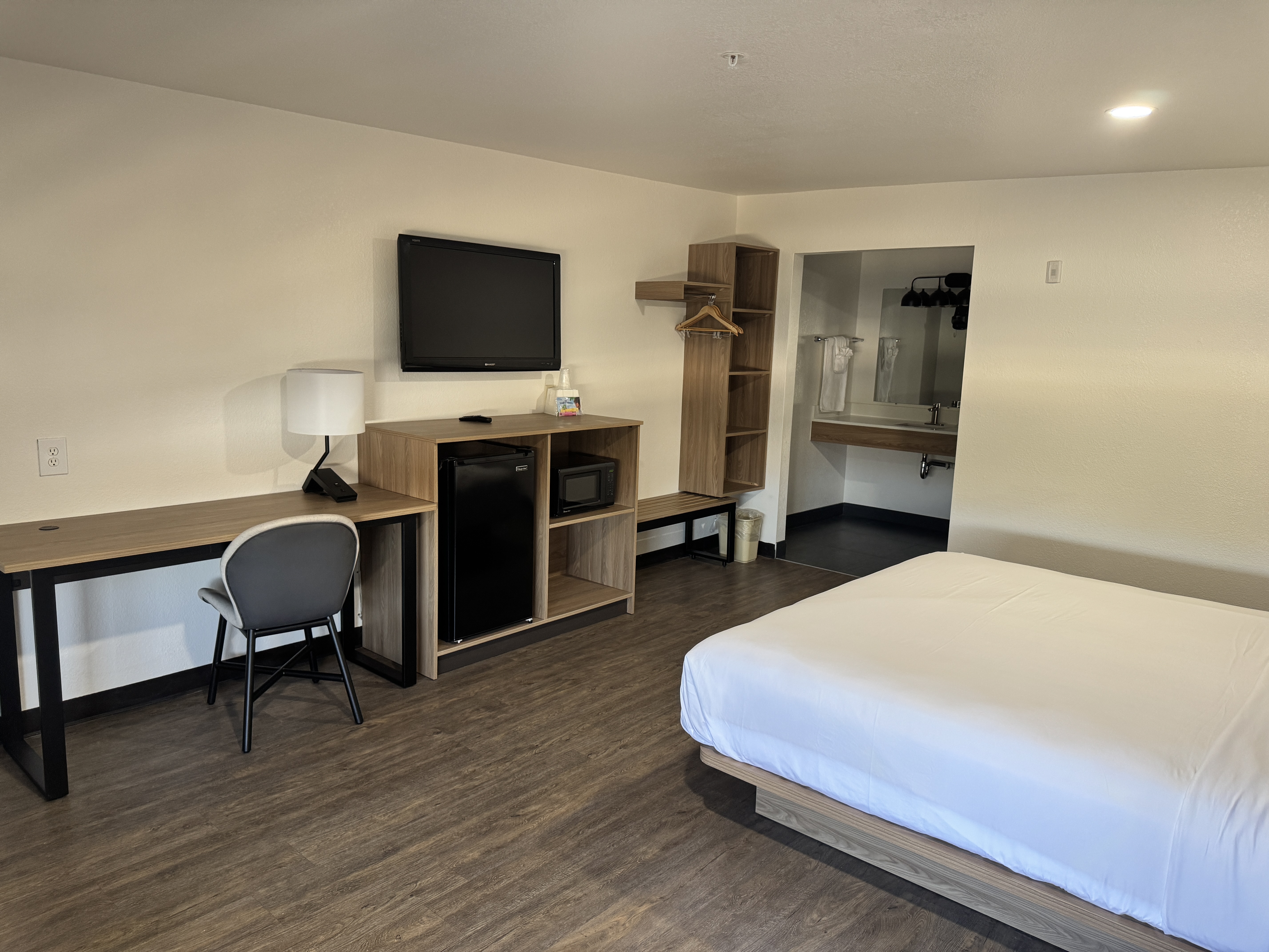 King room with modern headboard and bedside lighting