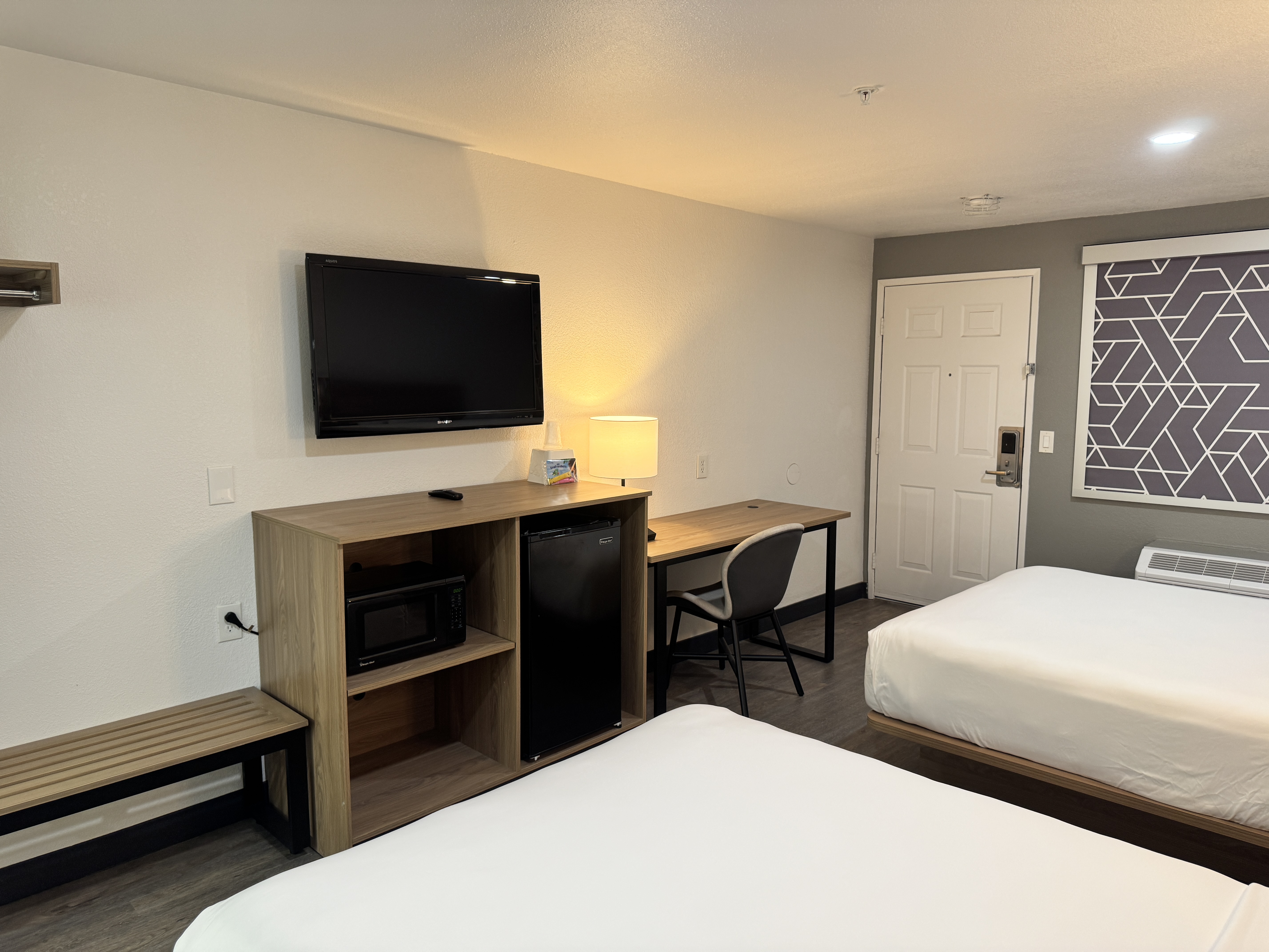 Two queen room with desk, television, microwave, and refrigerator